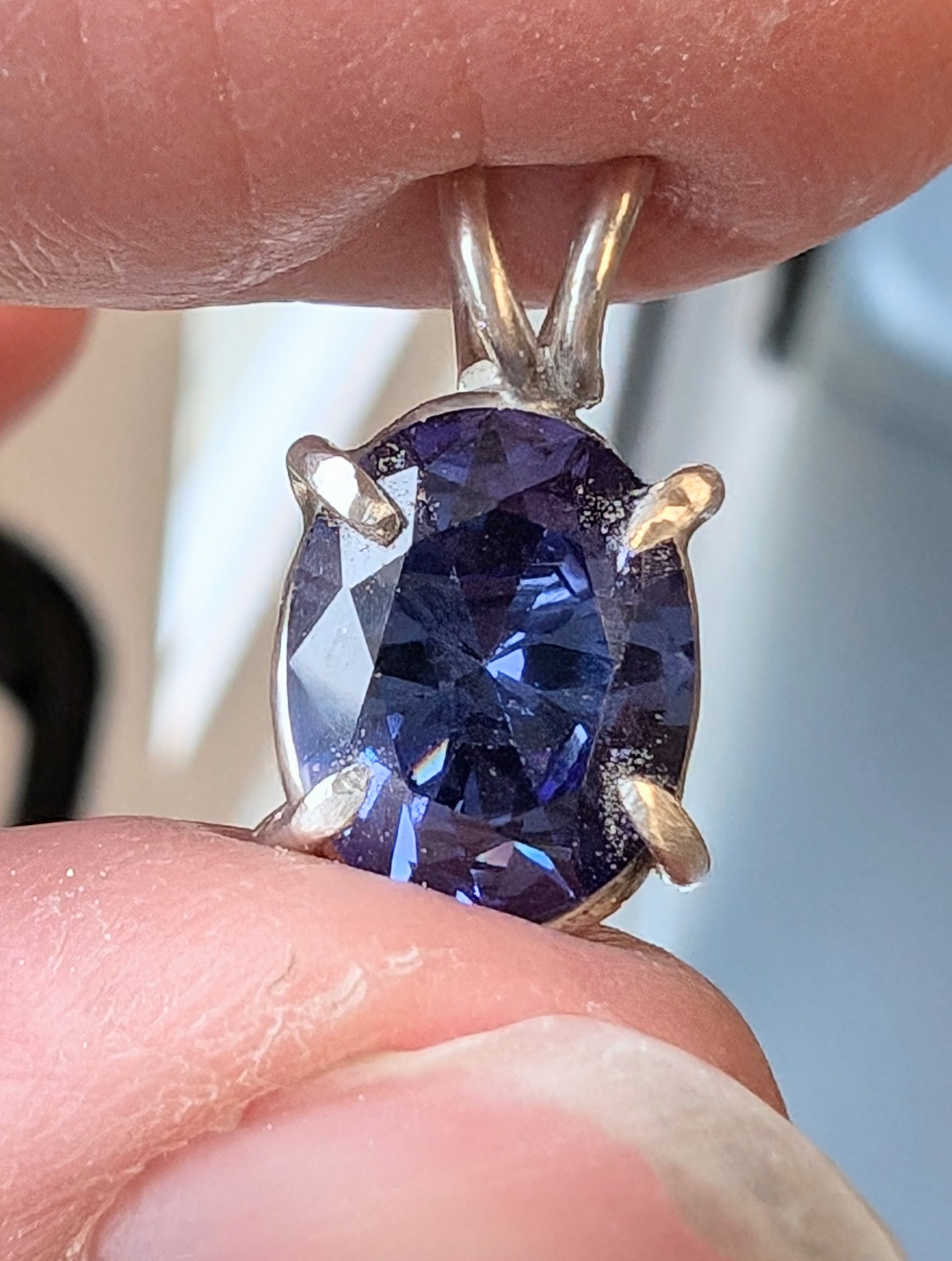 showing a tanzanite stone in fingers