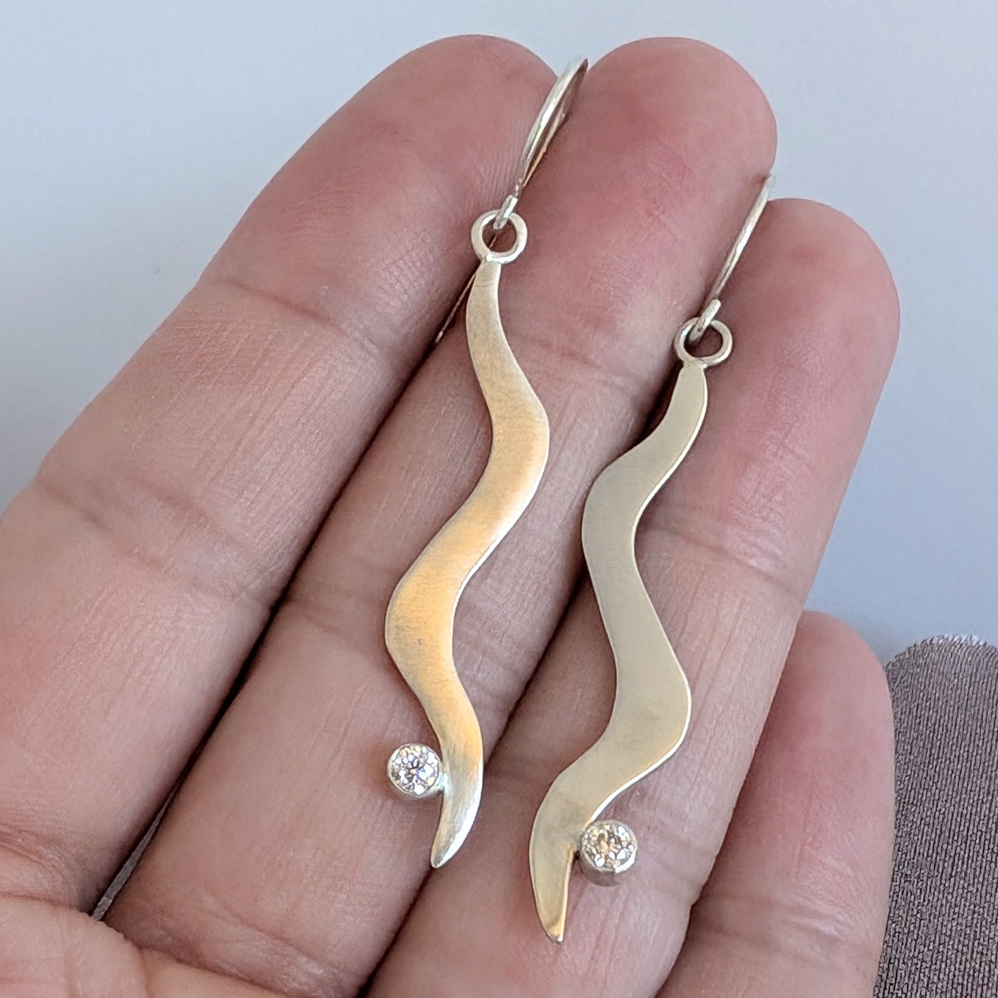 Silver and Moissanite wavy dangle earrings