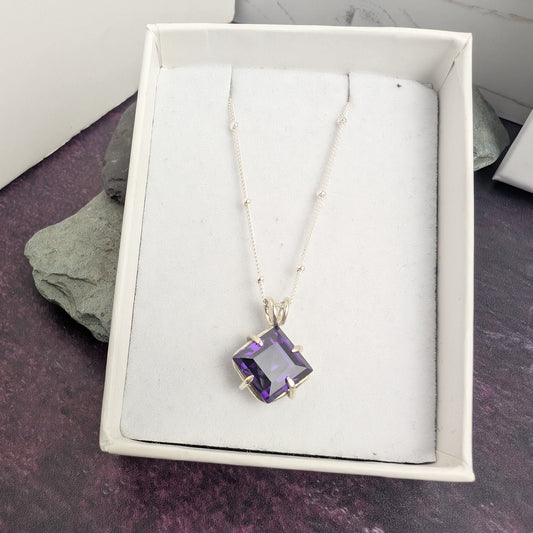 Claw set sparkle square purple stone necklace